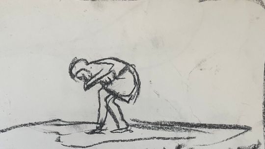 Boy collecting stones on beach